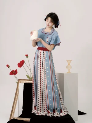 Front view of Alice Wonderland modern Hanfu outfit featuring a blue ruffled top, embroidered chest patch, maroon waistband, and playing-card print skirt