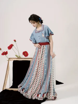 Three-quarter side view of Alice in Wonderland Tang Dynasty inspired modern Hanfu with dusty blue square-neck top and long printed skirt