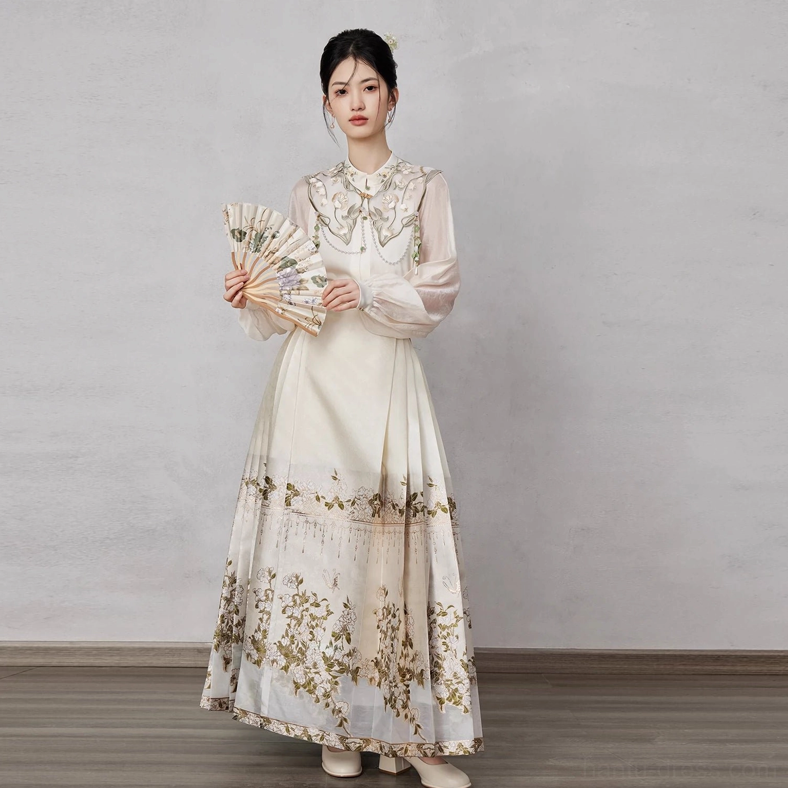 All-white modern Ming style Hanfu set with embellished cloud collar floor-length mamianqun horse face skirt and golden floral hem detail
