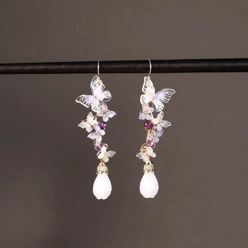 Front studio view of amethyst butterfly drop Cheongsam earrings with translucent purple butterflies, violet beads, white pendants and gold-tone hooks