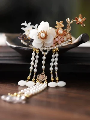 Antique-inspired Chinese Hanfu hairpin with gold floral branches white accents long pearl tassels and oval stone-style pendants