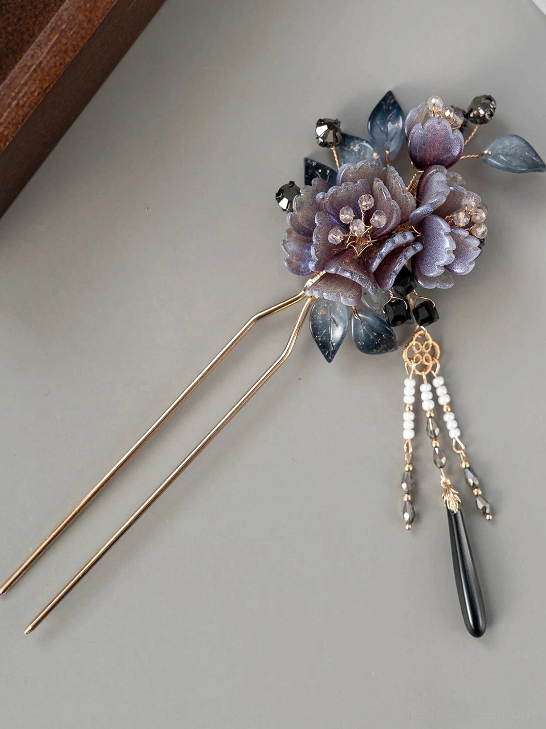 Antique-inspired U-shaped Chinese hair stick with double gold prongs, mauve peony decoration, blue resin leaves, white beads, and dark blue drop pendant