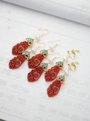 Hanfu red jade cloud earrings shown in hook and clip-on styles with gold-tone details on Chinese calligraphy paper