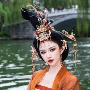 Close portrait of Ao Feng Yin Chinese phoenix bridal headdress with gold floral ornaments red accents and forehead tassel