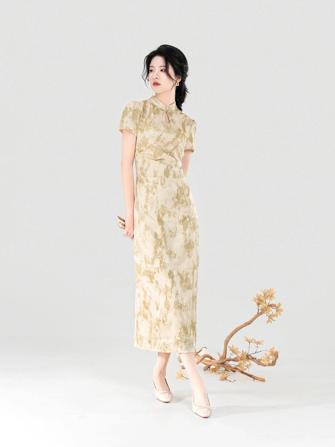 Side angle of apricot beige ink wash modern cheongsam dress with fitted waist and short stand collar