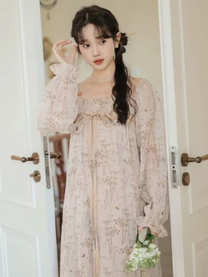 Front view of an apricot floral Tang-inspired Hanfu dress with sheer chiffon outer layer ruffled cuffs waist ribbon and delicate botanical print