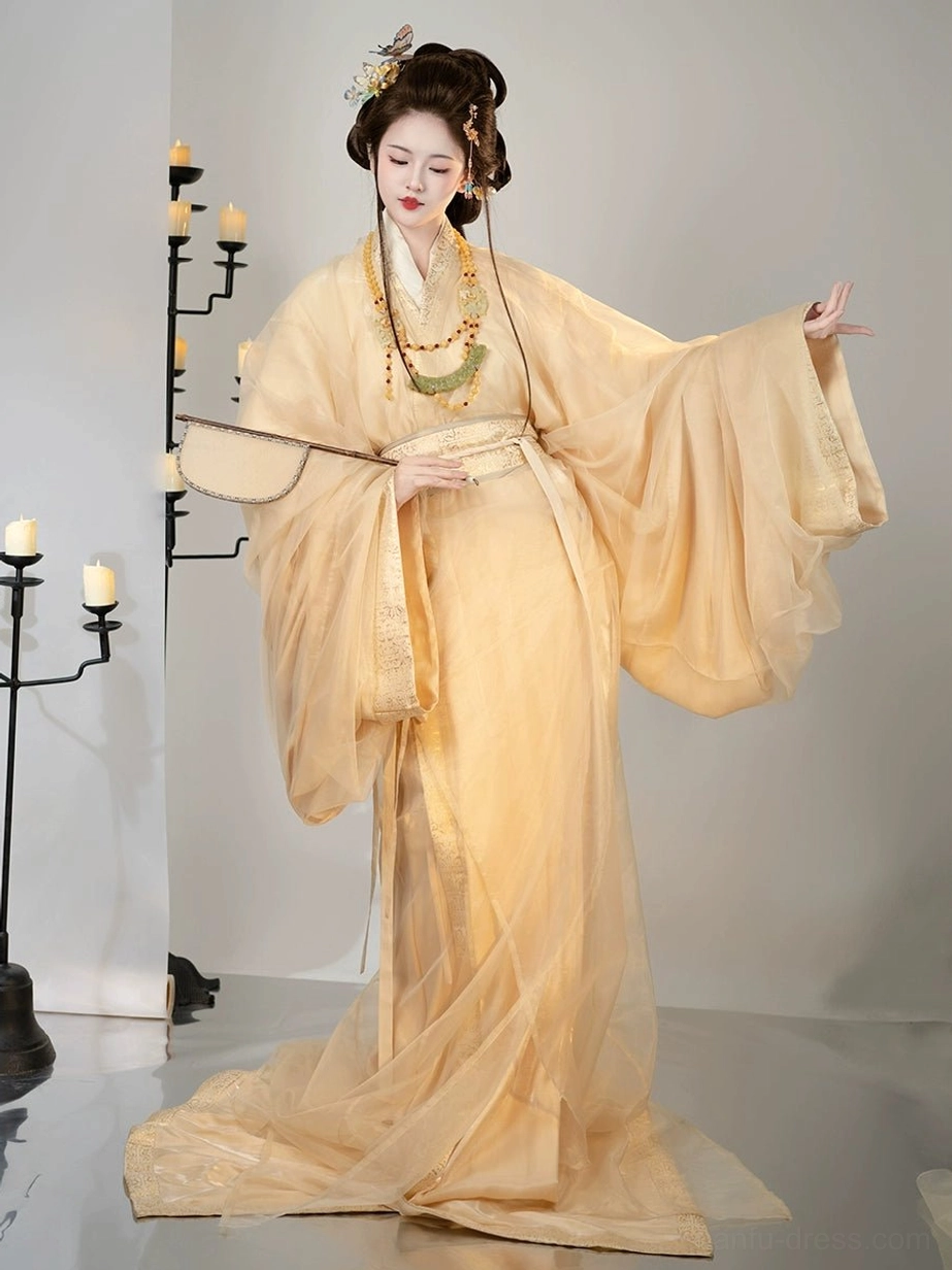 Apricot Han Dynasty Hanfu straight-hem robe complete set front view with flowing wide sleeves, waist sash, silk fan, and traditional Chinese hairstyle