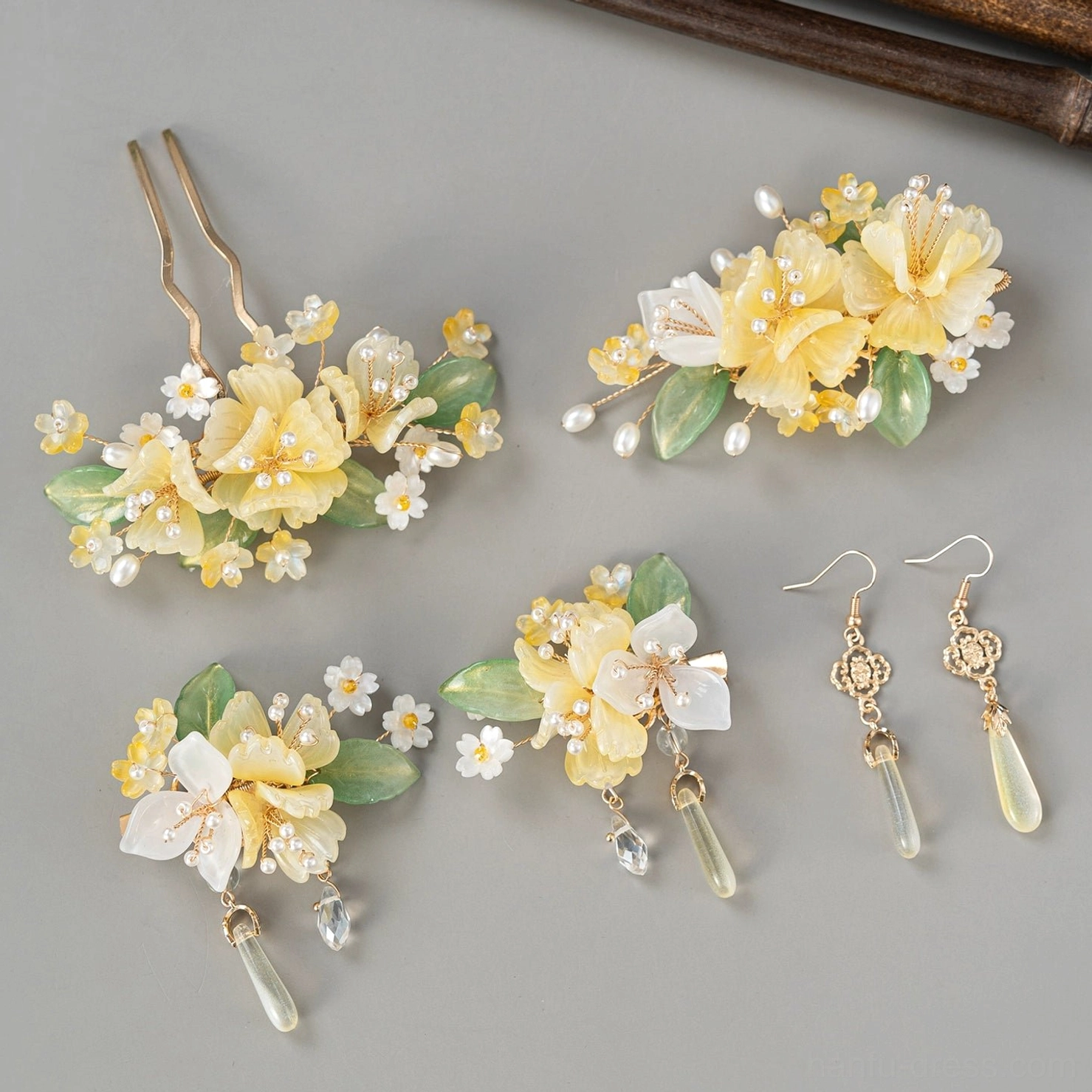Assorted yellow floral Hanfu hair accessories including hairpins clips and matching drop earrings in a yellow white green and gold color palette