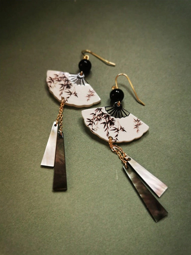 Asymmetric bamboo fan Chinese earrings with black and brown ink-style pendants, gold ear hooks, black beads, and mixed metal tassels