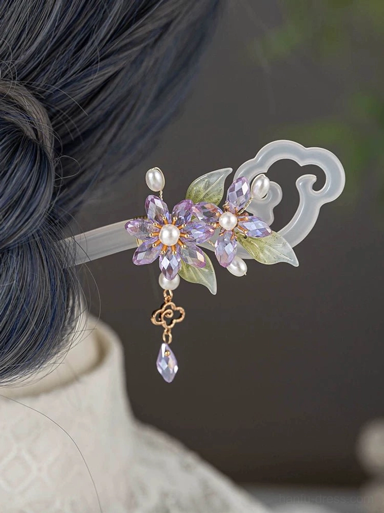 Aurora Night Chinese hair stick worn in a Hanfu-inspired hairstyle, featuring purple crystal flowers, faux pearls, green leaves, a cloud-shaped end, and a dangling gold-toned charm