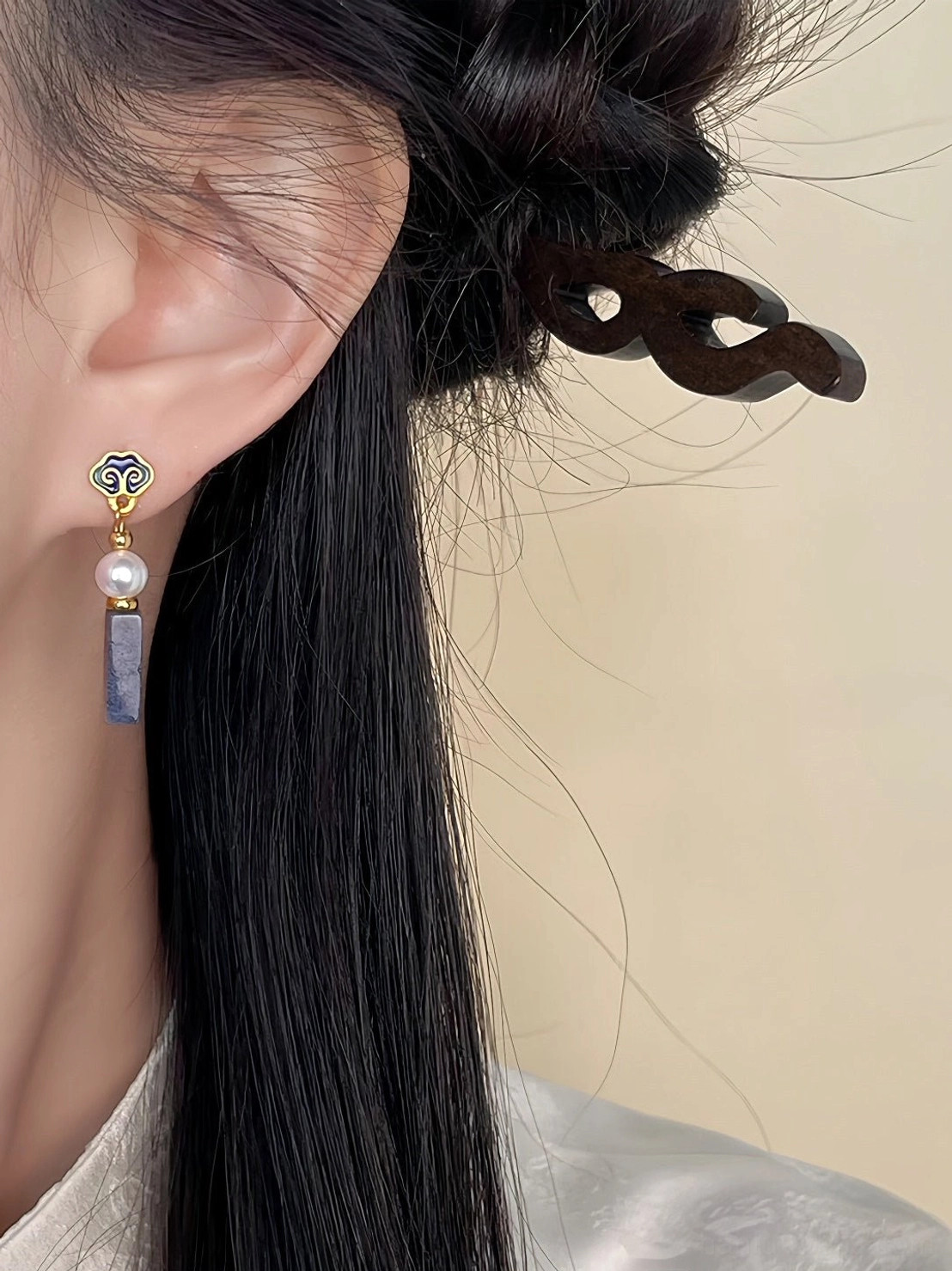 Pair of auspicious cloud drop earrings with gold cloud clasps, smooth freshwater pearls, and textured gray-blue stone pendants on white background