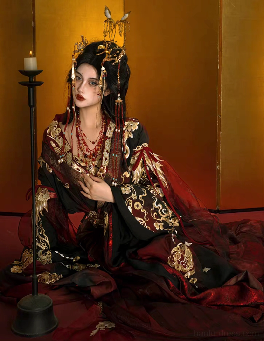 Side portrait of embroidered Qiyao Ruqun Hanfu in deep red and black showing gold collar waist and floor length skirt details
