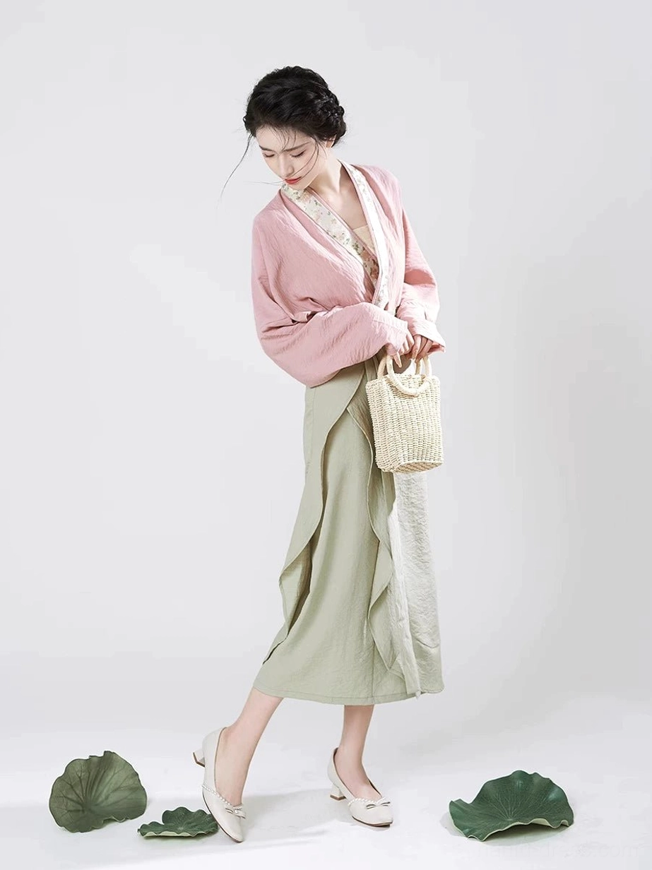 Side view of Autumn Lotus modern Song Dynasty Hanfu outfit with flowing green wrap skirt and straw handbag