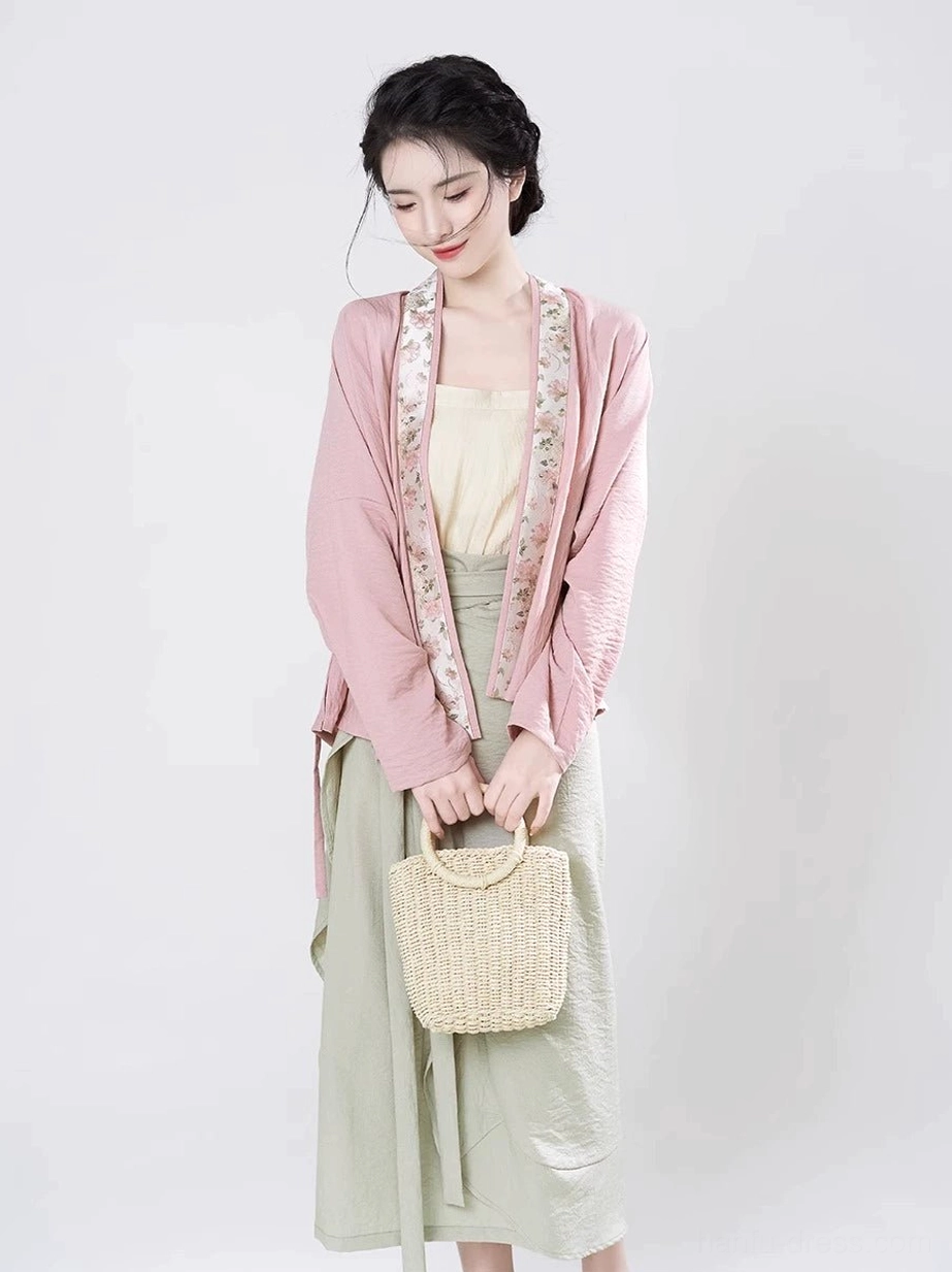 Front close view of Autumn Lotus Song Dynasty inspired Hanfu set with beige camisole pink cross-collar top and green skirt