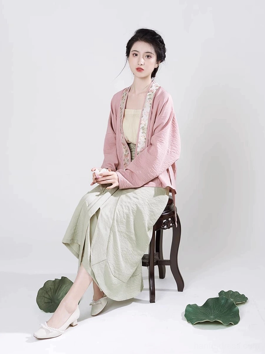 Seated model wearing Autumn Lotus Song Dynasty Hanfu full set with high waisted sage green wrap skirt and waist sash