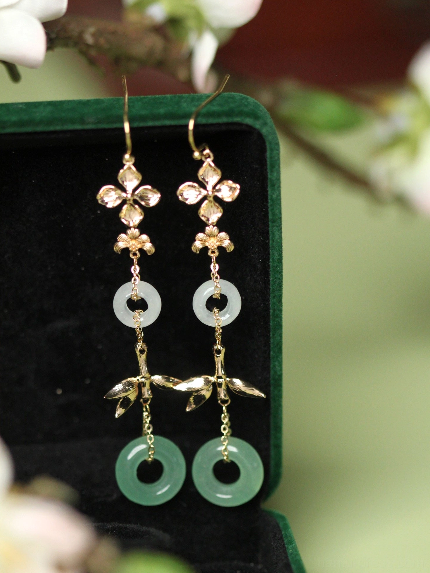 Aventurine jade style Hanfu earrings in a dark green velvet jewelry box with flower motifs bamboo charms and layered white and green rings