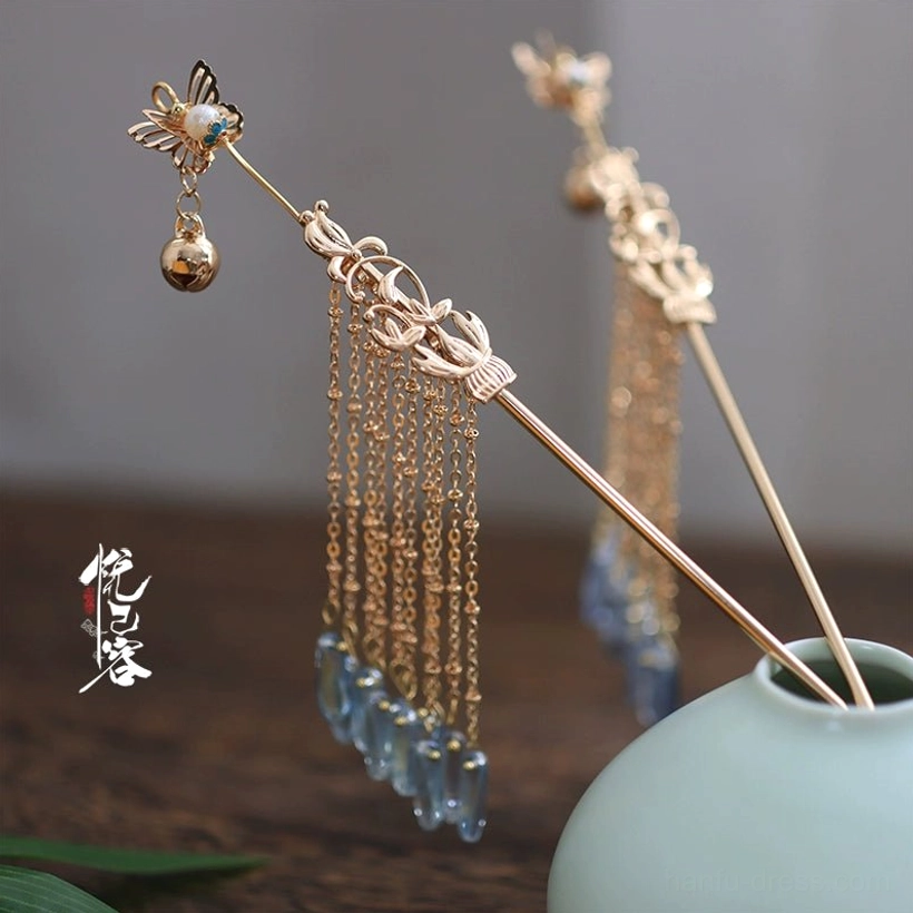 Close-up of Ayayun Mist butterfly Chinese hairpin featuring pearl detail blue green accents layered chain tassels and blue grey drops