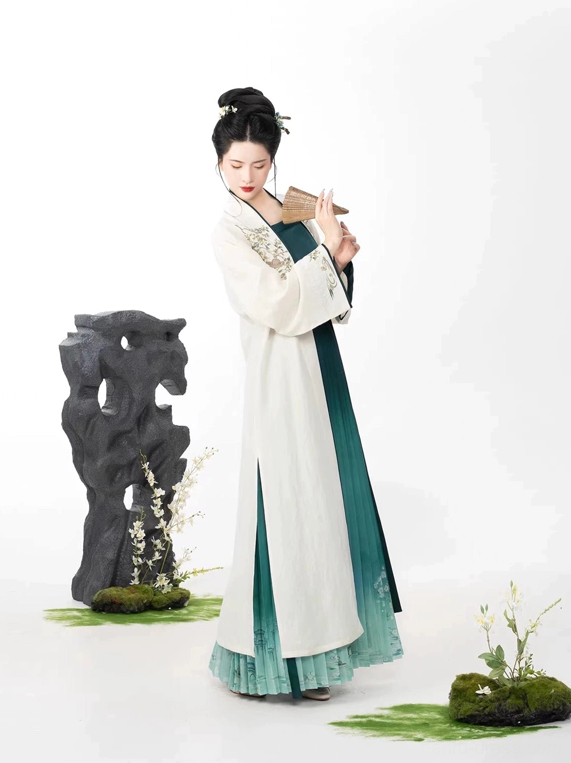 Bamboo Boat modern Hanfu outfit in an oriental garden studio featuring embroidered cardigan and teal pleated wrap skirt