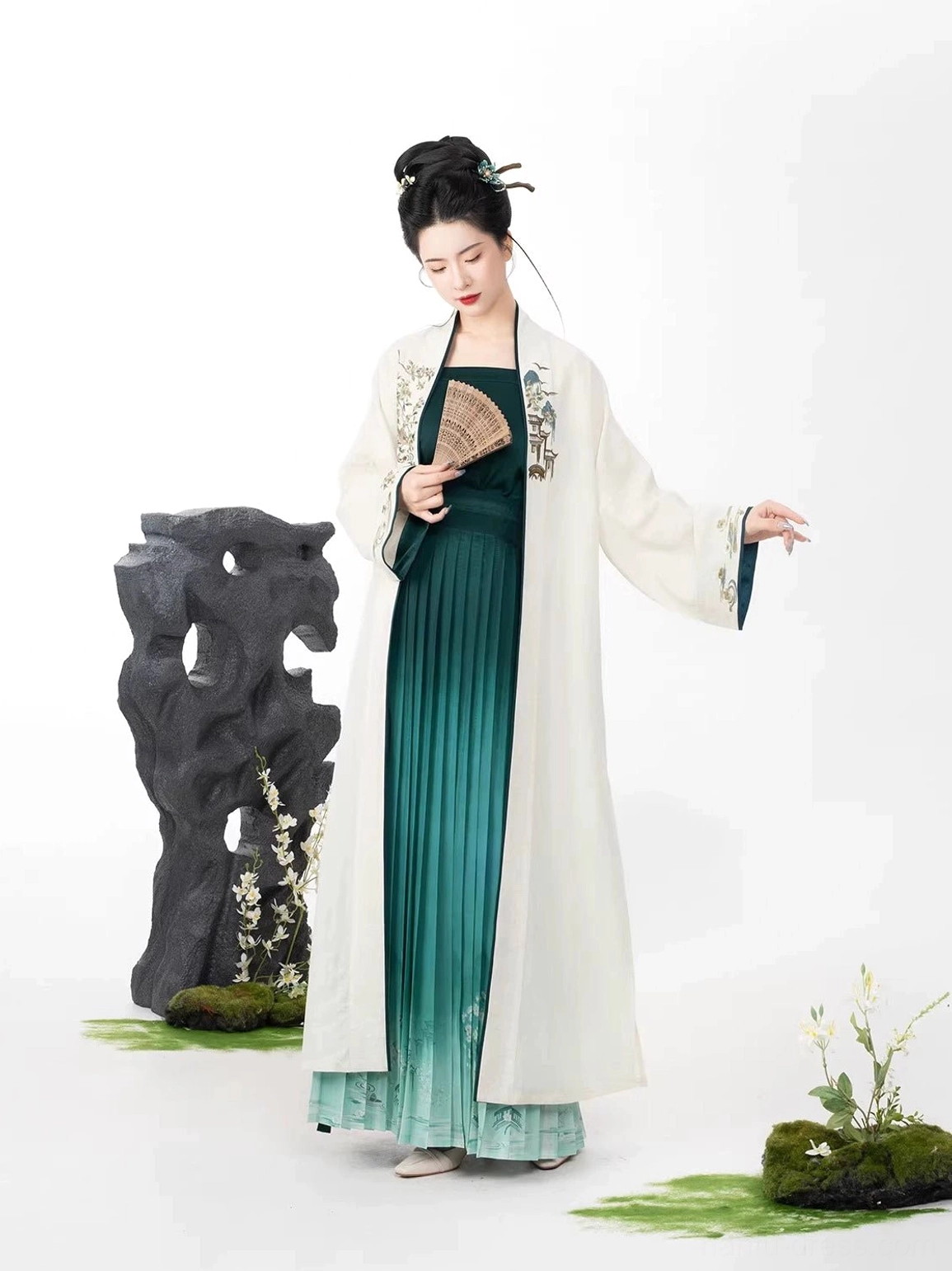 Three-quarter view of Song Dynasty inspired Hanfu set showing dark green cardigan trim and teal gradient pleated skirt