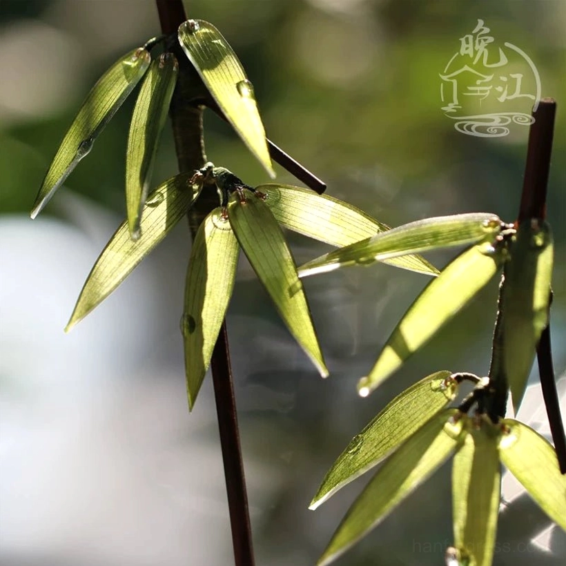 Close-up of bamboo leaf Chinese hair stick with clustered green leaves and glossy dewdrop decoration