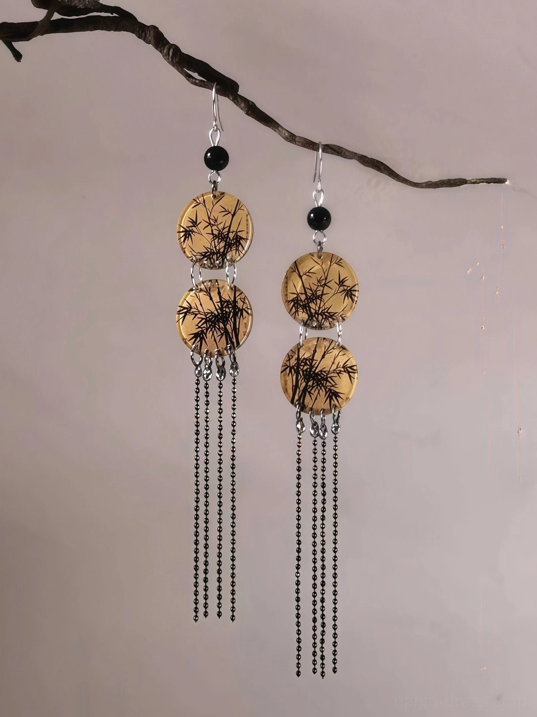 Front close-up of bamboo leaf round tassel earrings with silver hooks, black beads, ink-style bamboo print pendants, and long black chain tassels for Hanfu styling