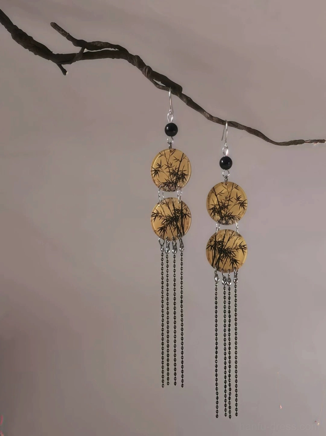 Side view of Chinese Hanfu bamboo leaf tassel earrings showing layered round pendants, silver hook ear wires, and long black beaded tassel movement