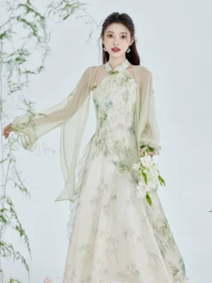 Three-quarter front view of bamboo print modern Hanfu cheongsam dress paired with sheer light green chiffon-style cardigan