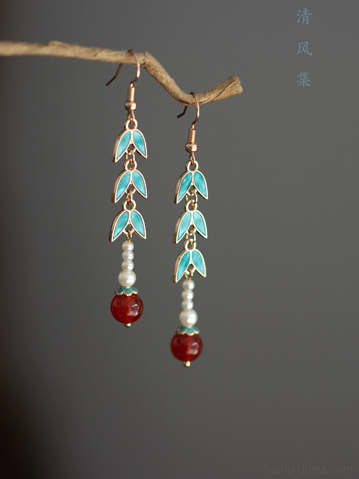 Minimalist bamboo Hanfu drop earrings with blue enamel leaves imitation pearls and red agate style pendants on gray background