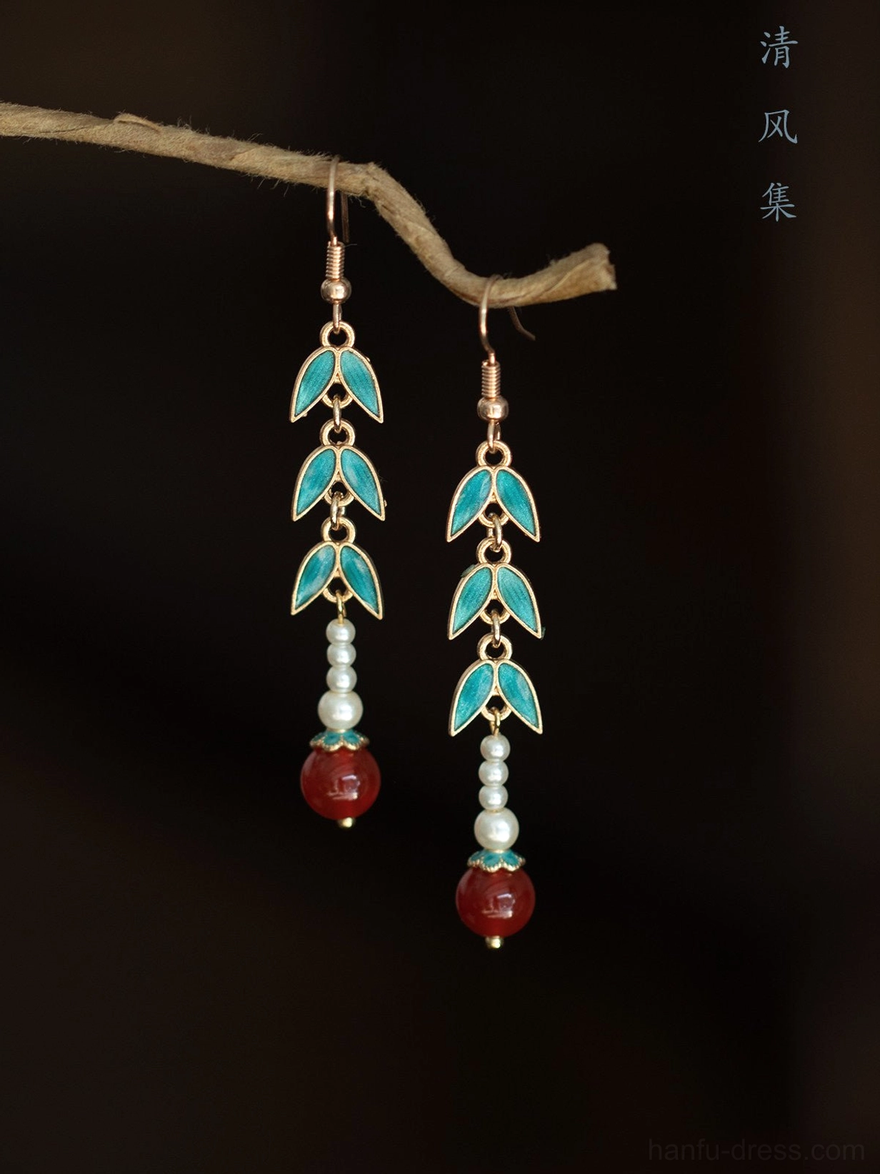 Matching pair of bamboo inspired Chinese earrings with enamel leaves white pearl accents and red agate style drops