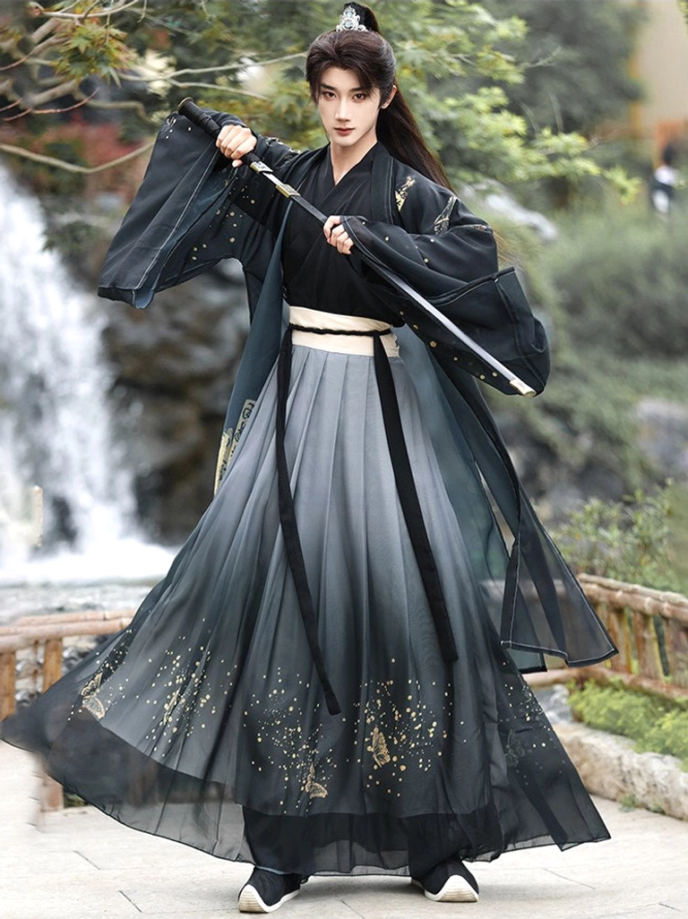 Men’s wuxia hanfu costume in a dynamic waterside pose with long sword, wide flowing sleeves, ink gradient skirt, and gold speckle accents