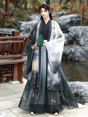 Bamboo Rhyme men’s Xianxia hanfu set in an outdoor Chinese garden, front view showing ink-wash gradient robe, bamboo motif, gold accents, and flowing pleated layers