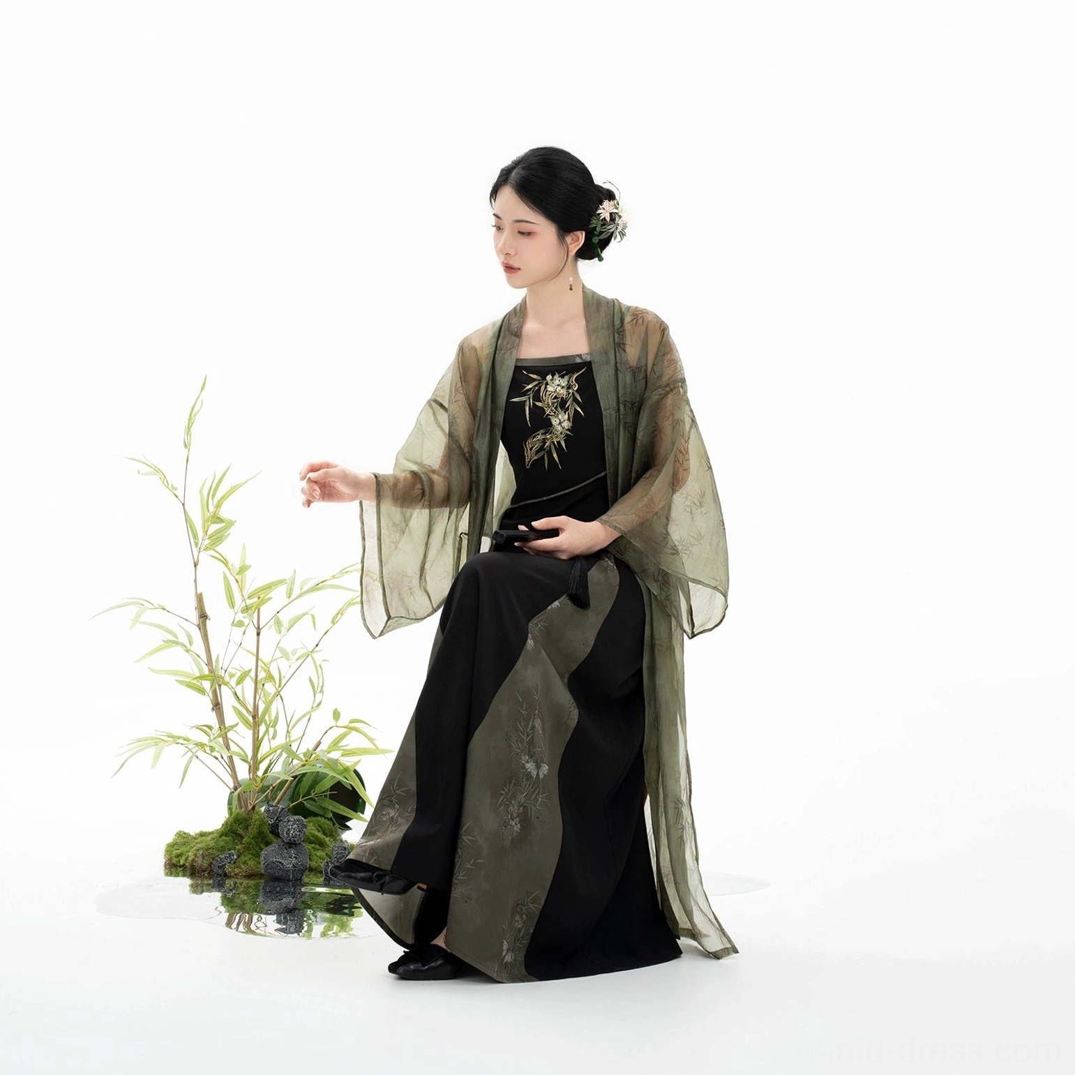 Close seated view of black Bamboo Shadow slip dress with golden bamboo embroidery from modern Song Dynasty Hanfu set