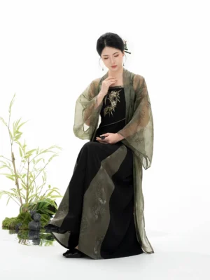Seated side view of Bamboo Shadow modern Song Dynasty Hanfu set with ink wash sheer beizi and bamboo landscape styling