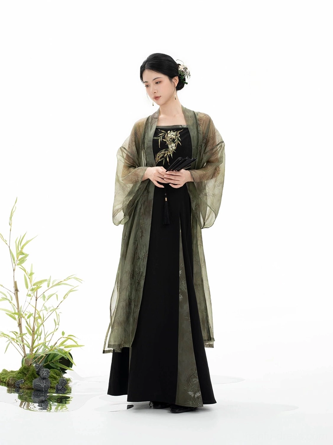 Three quarter front view of Bamboo Shadow Song Dynasty Hanfu with long translucent olive beizi and black floor length slip dress