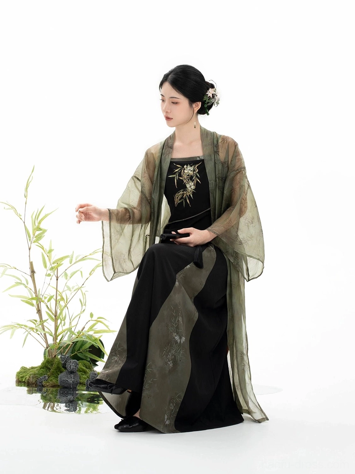 Seated Bamboo Shadow Song Dynasty Hanfu outfit showing olive green dress side panel and delicate floral hair accessory
