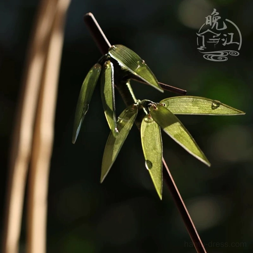 Bamboo themed Chinese hairpin with green leaf cluster and dewdrop details in warm natural light