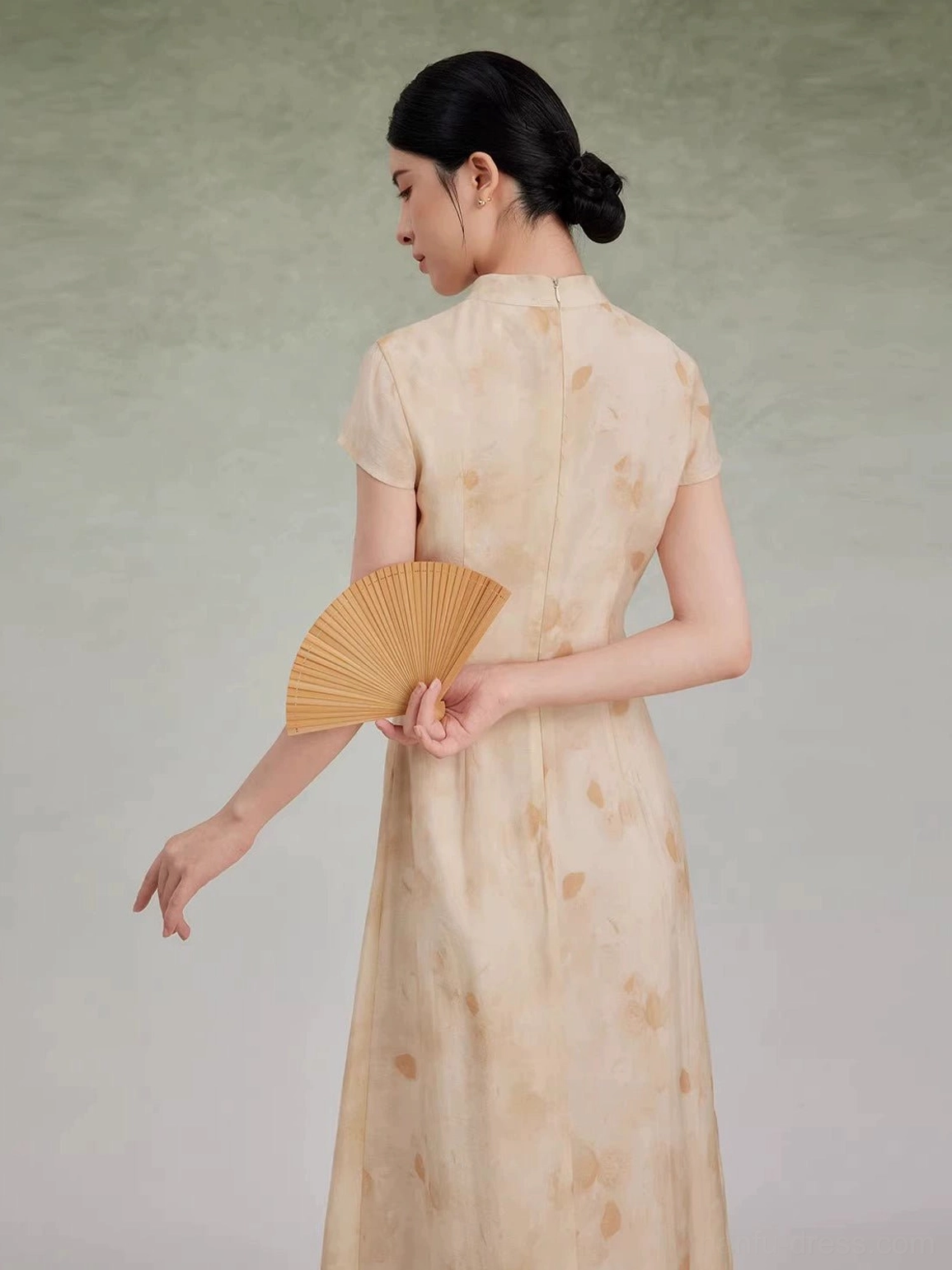 Back view of beige floral New Chinese Style qipao maxi dress with cap sleeves and tailored silhouette