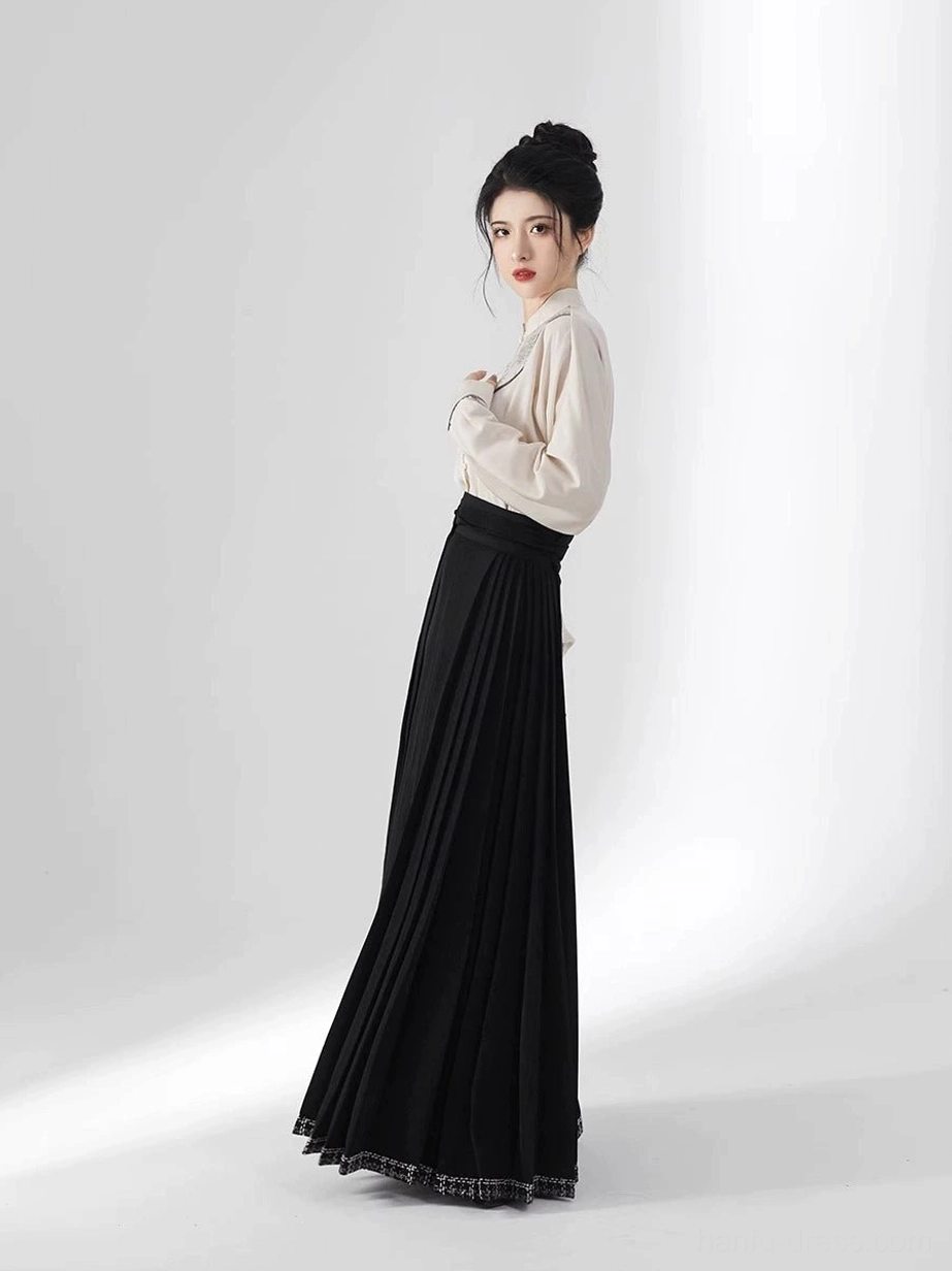 Side view of beige long sleeve stand-collar Hanfu top and black pleated Ming Dynasty inspired mamianqun