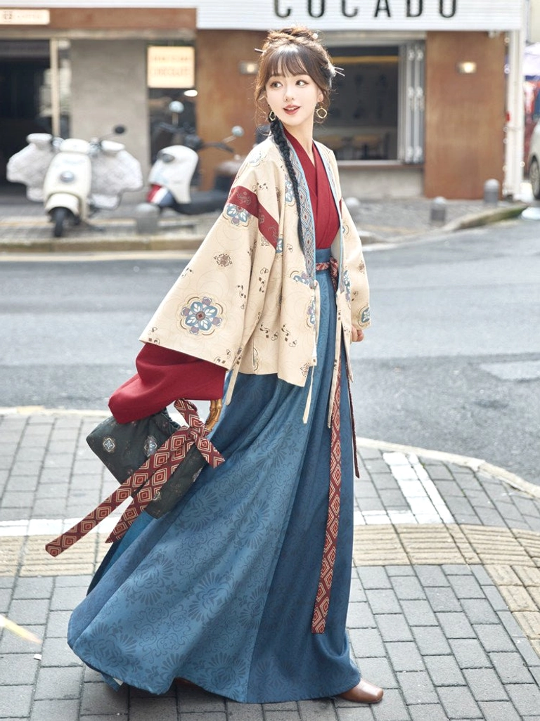 Beige modern hanfu cropped jacket and long navy skirt shown from the side and back with geometric shoulder trims, cuff details, and crossbody bag