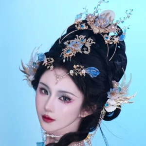 Side view of Bihai Ballad Hanfu hair accessories with blue floral hairpins, forehead chain, pearl tassels, and gold-tone ornaments on a blue Hanfu hairstyle