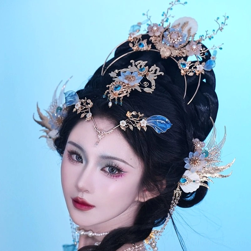 Side view of Bihai Ballad Hanfu hair accessories with blue floral hairpins, forehead chain, pearl tassels, and gold-tone ornaments on a blue Hanfu hairstyle