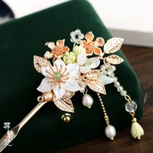 Biluo white flower and green tassel Hanfu hairpin displayed on dark green velvet with gold toned floral details and pearl-like bead strands