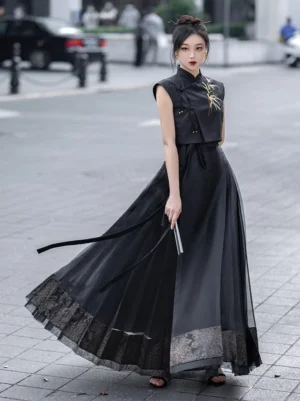 Black bamboo embroidered Chinese sleeveless crop top styled with a flowing black skirt in a modern Hanfu inspired street outfit