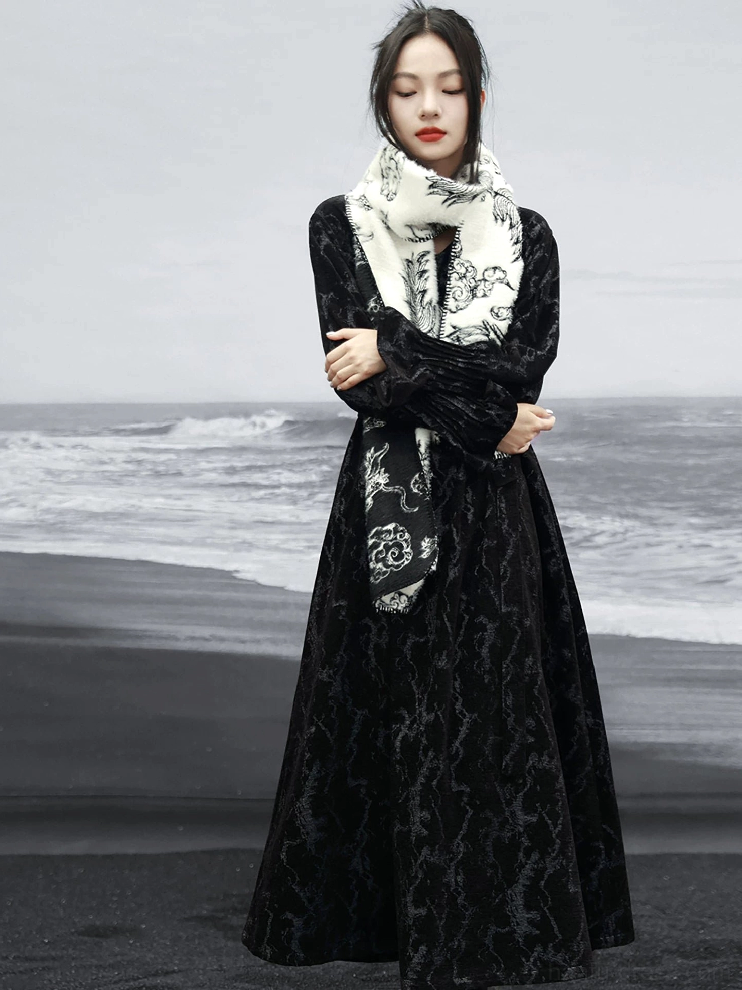 Front view of a black chenille-textured modern Hanfu maxi dress styled with a printed scarf, V-neck halter detail, flowing sleeves, and loose fit
