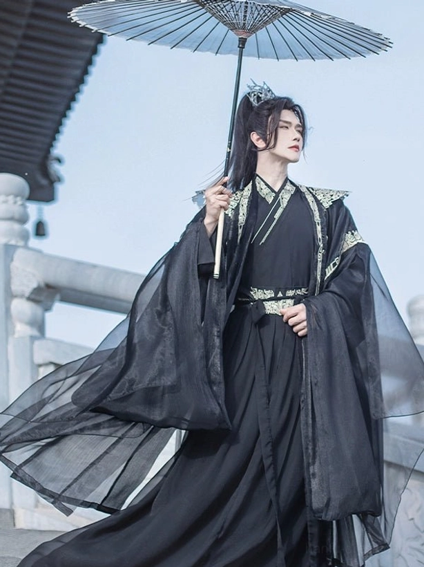 Black Chinese fantasy hanfu costume for men with crossover collar, embroidered shoulder details, sheer robes, and paper umbrella