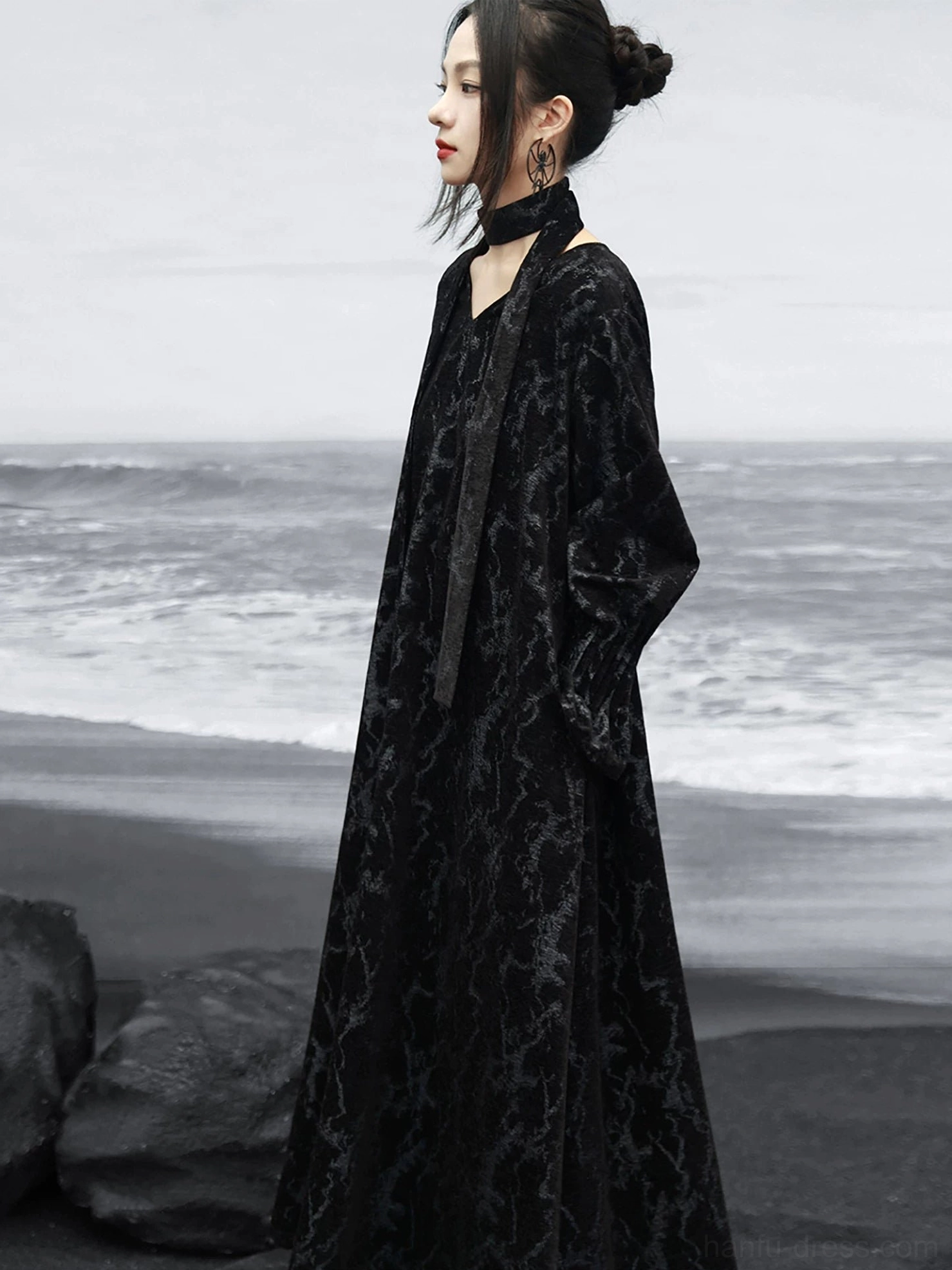 Side view of a black Chinese-inspired modern Hanfu maxi dress featuring a halter neck sash, full-length loose fit, and dark cracked jacquard pattern