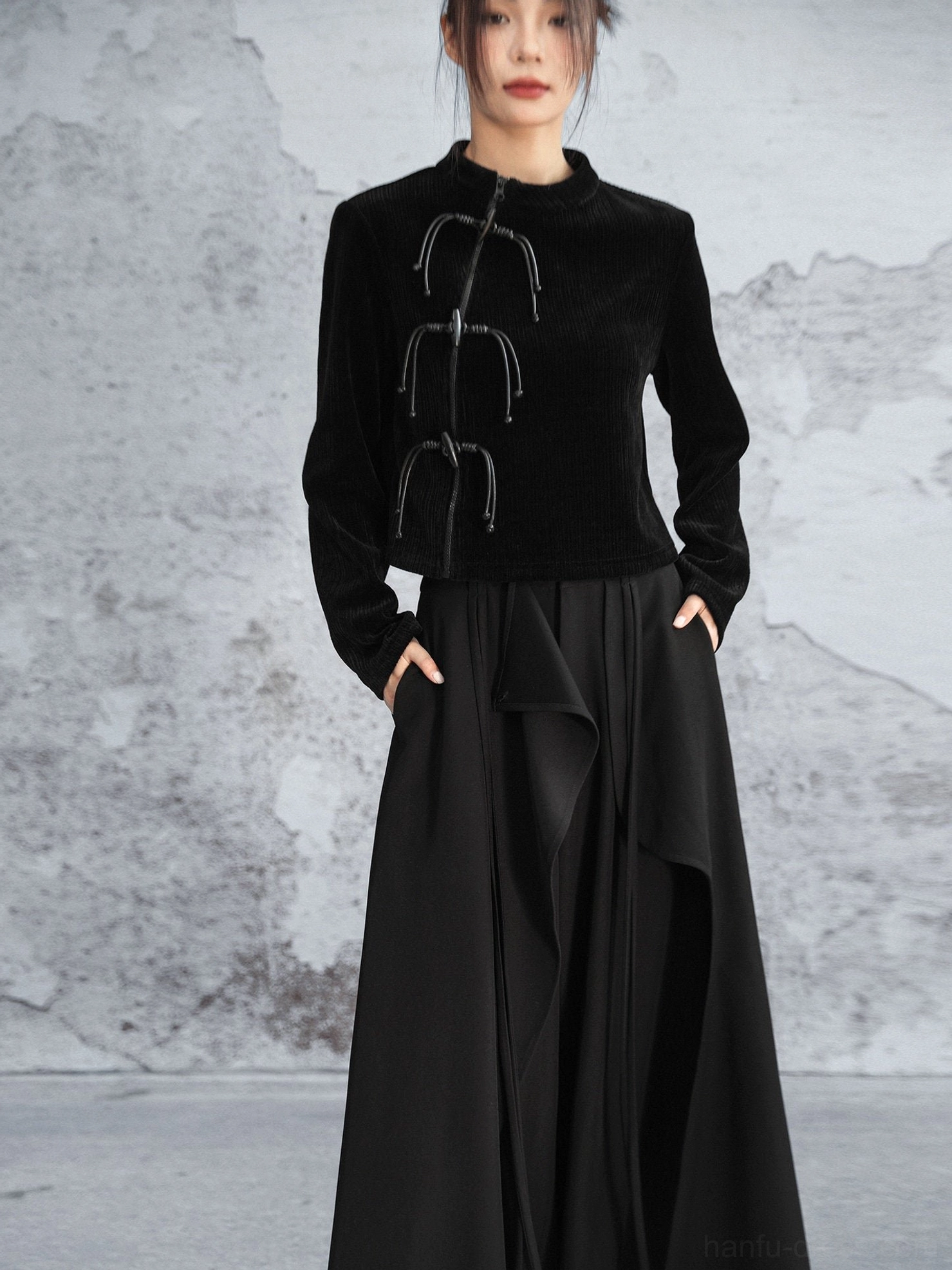 Full-body front view of a black Chinese-style modern Hanfu knit sweater paired with a flowing long black skirt and featuring a stand collar and frog closures
