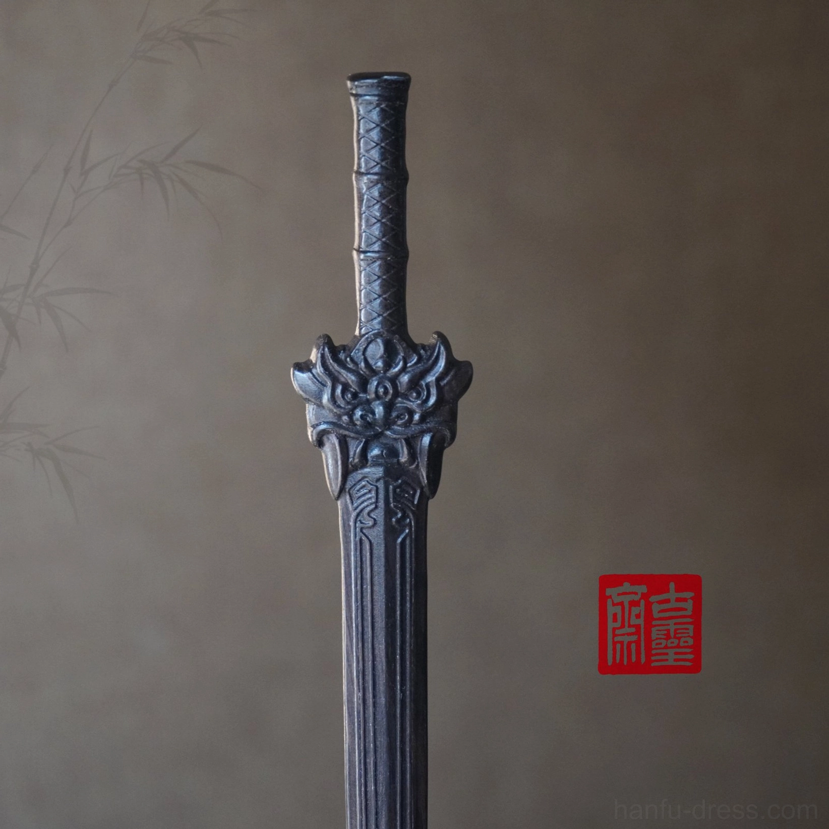 Black Chinese sword hair stick shown from the front with carved mythical beast decoration, wrapped textured handle, and engraved blade-inspired patterns