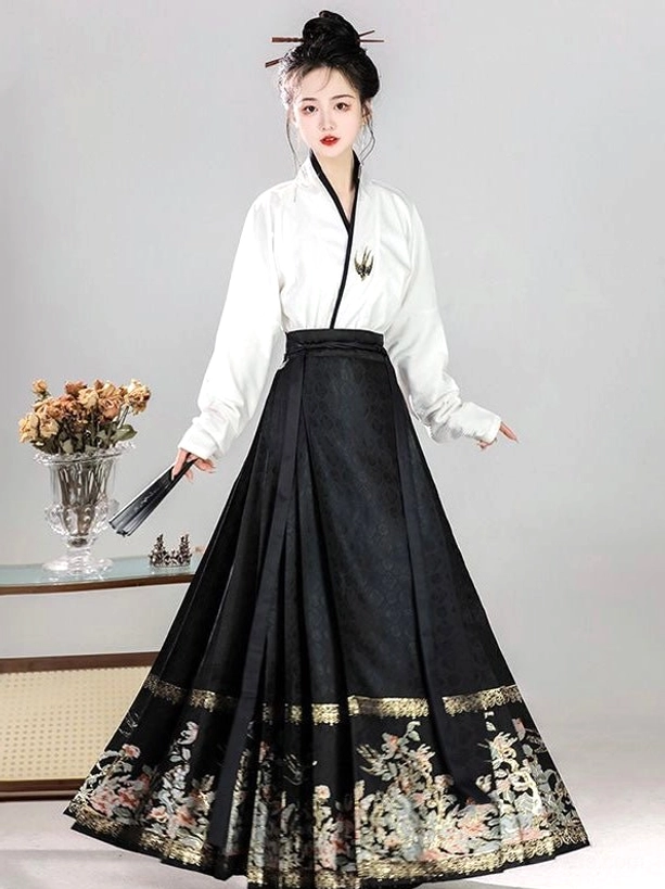Three-quarter side view of black floral embroidered mamianqun horse face skirt with white Ming-style Hanfu top