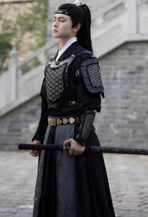 Front full body view of black fantasy general hanfu for men with shoulder armor, arm bracers, gold buckles, embroidered dark skirt, and sword